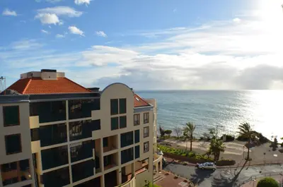 a view of the ocean from a building at Golden View by Homie in Funchal