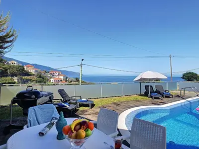 a bowl of fruit on a table next to a swimming pool at Villa North Sea by LovelyStay in Ponta Delgada