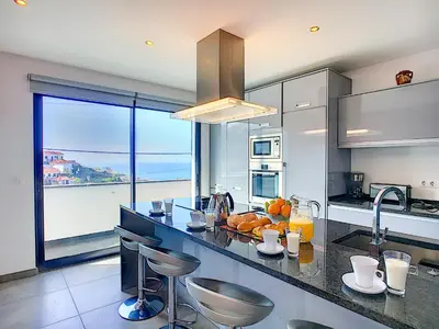 a kitchen with a counter with a view of the ocean at Villa North Sea by LovelyStay in Ponta Delgada