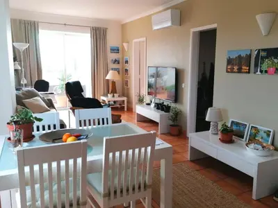 a living room with a table and chairs and a couch at Sweden Apartment - Top Floor one bedroom with sea views - RS in Lagos