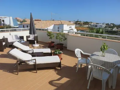 a patio with chairs and tables on a roof at Sweden Apartment - Top Floor one bedroom with sea views - RS in Lagos