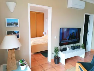 a living room with a television and a bed at Sweden Apartment - Top Floor one bedroom with sea views - RS in Lagos