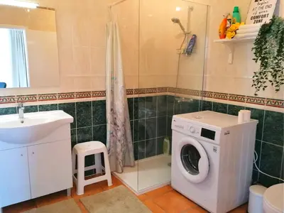 a bathroom with a washing machine and a sink at Sweden Apartment - Top Floor one bedroom with sea views - RS in Lagos