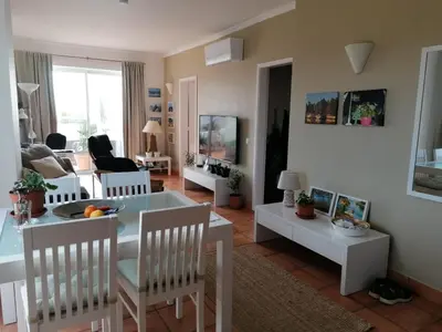 a living room with a white table and chairs at Sweden Apartment - Top Floor one bedroom with sea views - RS in Lagos