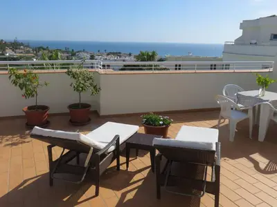 a patio with tables and chairs on a roof at Sweden Apartment - Top Floor one bedroom with sea views - RS in Lagos