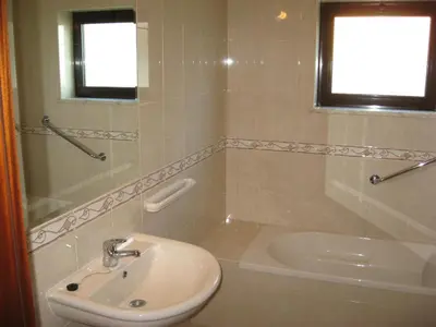 a bathroom with a sink and a toilet and a tub at Esti Chamaco - Lagos in Lagos