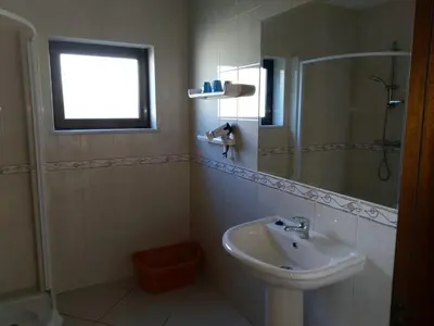 a kitchen with a table and a sink at Esti Chamaco - Lagos in Lagos