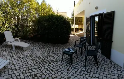 two chairs and a table with cups and saucers at Esti Chamaco - Lagos in Lagos
