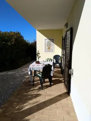 a patio with two chairs and a table and two chairs at Esti Chamaco - Lagos in Lagos