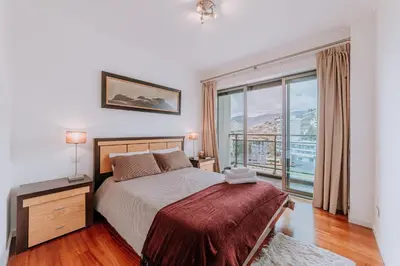 a bedroom with a bed and a large window at Cozy T2 with Ocean View in Funchal