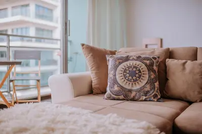 a pillow sitting on a couch in a living room at Cozy T2 with Ocean View in Funchal