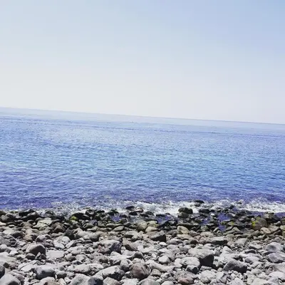 a group of rocks on a beach near the water at Mansion Almond - SEA, SUN and a charming refuge! in Paul do Mar