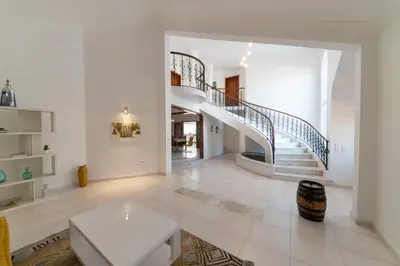 a white living room with a spiral stair case at Mansion Almond - SEA, SUN and a charming refuge! in Paul do Mar