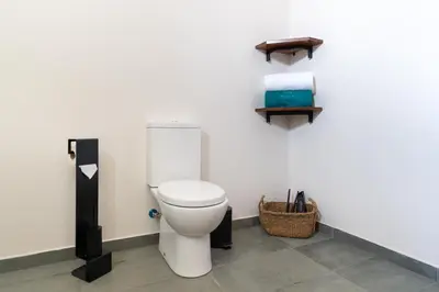 a bathroom with a toilet in a room at Rochão Village by Rent2U, Lda in Calheta