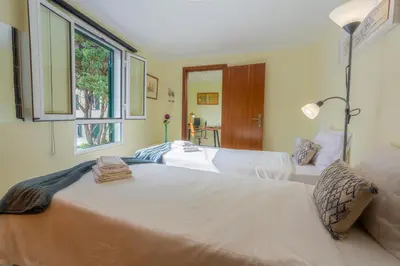a bedroom with two beds and a window at Mateus House - Porto da Cruz Center in Porto da Cruz