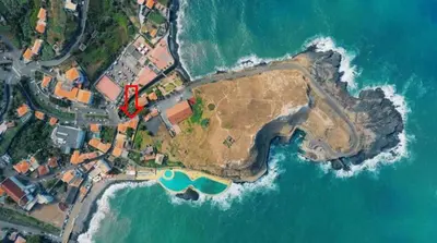 a group of people in the water at a beach at Mateus House - Porto da Cruz Center in Porto da Cruz