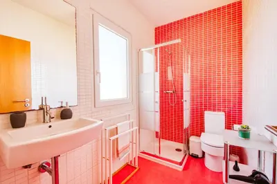a bathroom with a sink and a toilet and red tiles at Madeira Offline by Amazing Madeira in Ponta Delgada