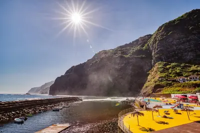 a view of a beach with a mountain at Madeira Offline by Amazing Madeira in Ponta Delgada