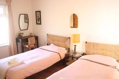 a bedroom with two beds and a mirror at Amazing Beach House in Algarve with Sea View! in Luz