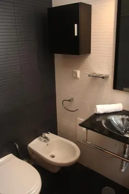 a bathroom with a white toilet and a sink at Amazing Beach House in Algarve with Sea View! in Luz