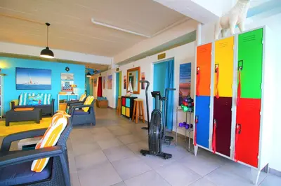 a room with colorful doors and a gym at The Waves Hostel by Amazing Madeira in São Vicente