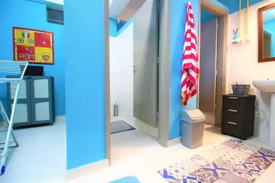 a bathroom with an american flag in a room at The Waves Hostel by Amazing Madeira in São Vicente