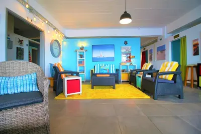 a childrens play room with blue walls and chairs at The Waves Hostel by Amazing Madeira in São Vicente