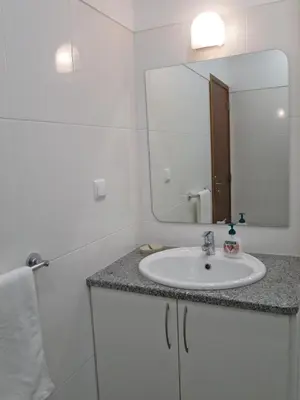 a bathroom with a sink and a mirror at Market Downtown T3 in Funchal