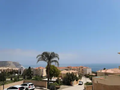a view of a city with a palm tree and buildings at OCEAN VIEW VILLA BELAMAR in Luz