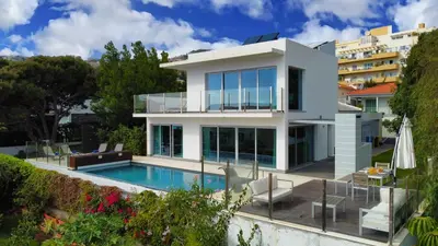 a villa with a swimming pool and a house at Villa Madeira by LovelyStay in Caniço