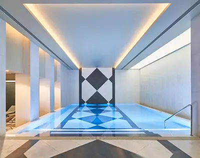 a swimming pool with a blue floor in a room at Savoy Palace - The Leading Hotels of the World - Savoy Signature in Funchal