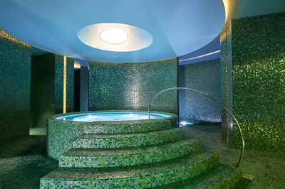 a bathroom with a jacuzzi tub with stairs in it at Savoy Palace - The Leading Hotels of the World - Savoy Signature in Funchal