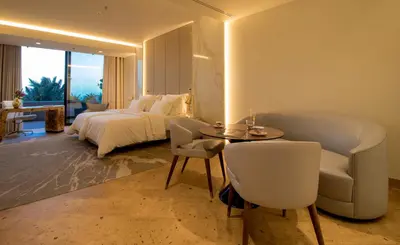 a bedroom with a bed and a table and chairs at Savoy Palace - The Leading Hotels of the World - Savoy Signature in Funchal