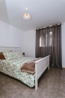 a bedroom with a bed and a window at Fortaleza do Pico Apartment in Funchal