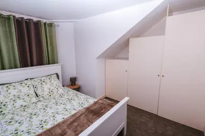 a small bedroom with a bed and a staircase at Fortaleza do Pico Apartment in Funchal