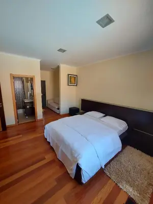 a bedroom with a large white bed in a room at Quintinha do Álvaro - Holiday house in Santana