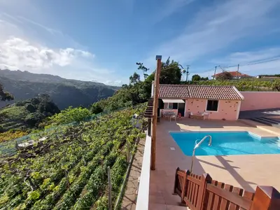 a villa with a pool and a view of a vineyard at Quintinha do Álvaro - Holiday house in Santana