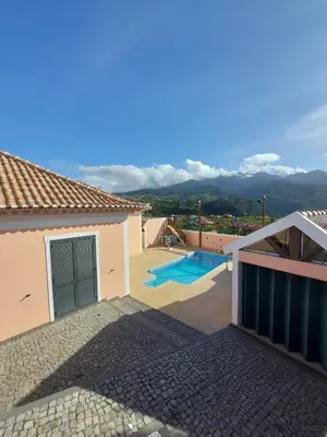 a villa with a swimming pool and a house at Quintinha do Álvaro - Holiday house in Santana