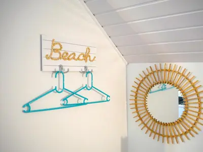 a bathroom with a mirror and a beach sign at Casa do pescador in Machico