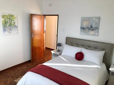 a bedroom with a bed with a red flower on it at City View Gardens II in Funchal