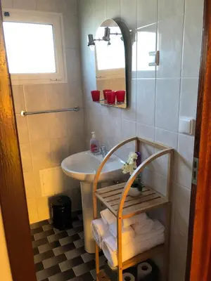 a bathroom with a sink and a mirror at City View Gardens II in Funchal