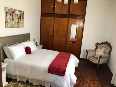 a bedroom with a bed with a red blanket on it at City View Gardens II in Funchal