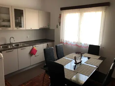 a kitchen with a table and chairs and a sink at City View Gardens II in Funchal