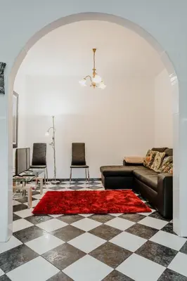 a living room with a couch and a red rug at City View Gardens I in Funchal