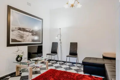 a living room with a couch and two chairs at City View Gardens I in Funchal