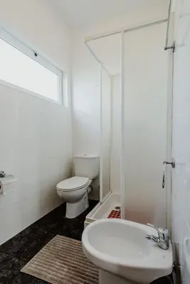 a white bathroom with a toilet and a sink at City View Gardens I in Funchal