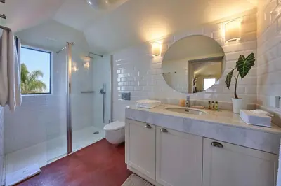 a bathroom with a sink and a toilet and a mirror at Bordal Houses in Funchal