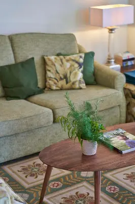a living room with a couch and a table at Bordal Houses in Funchal