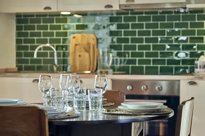 a table with glasses and plates on it in a kitchen at Bordal Houses in Funchal