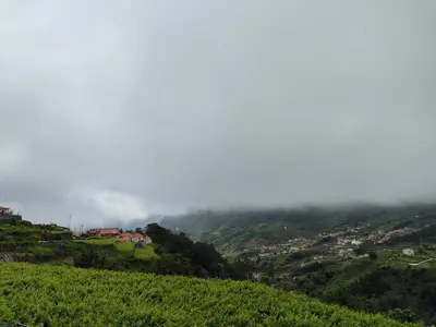 a town on a hill in the clouds at Matilde House in São Vicente